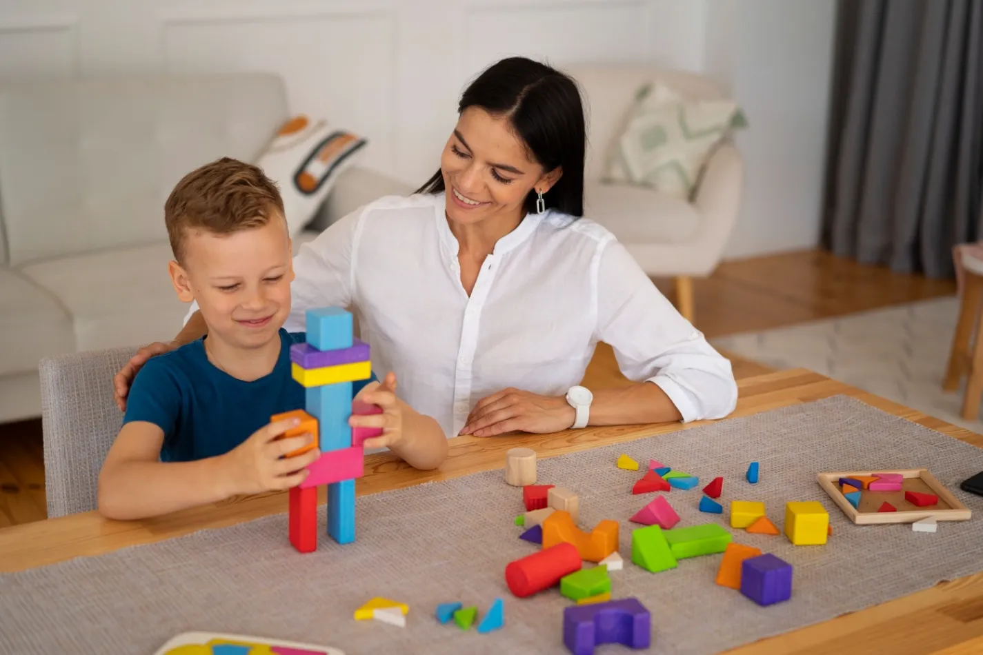 Child with their mom playing a brain teaser